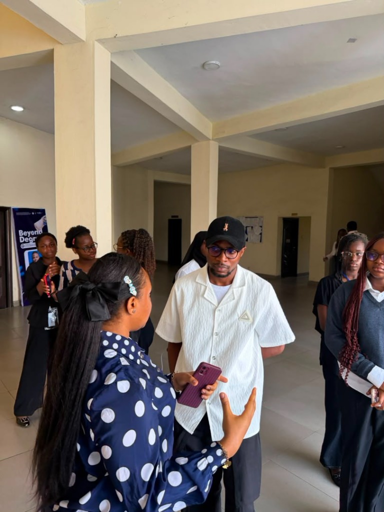 Christian Damiete Thankgod speaking with organizers at Beyond Degrees Conference